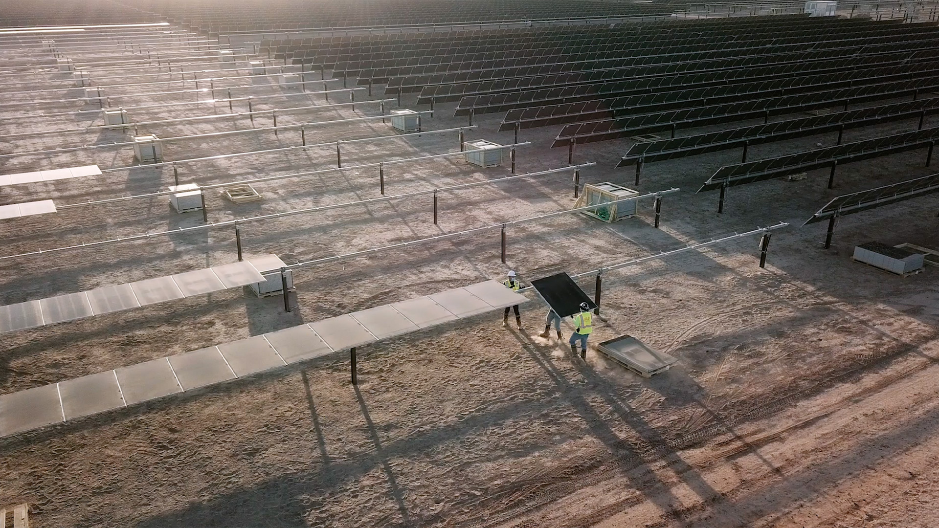 Workers lifting up solar panel to install it