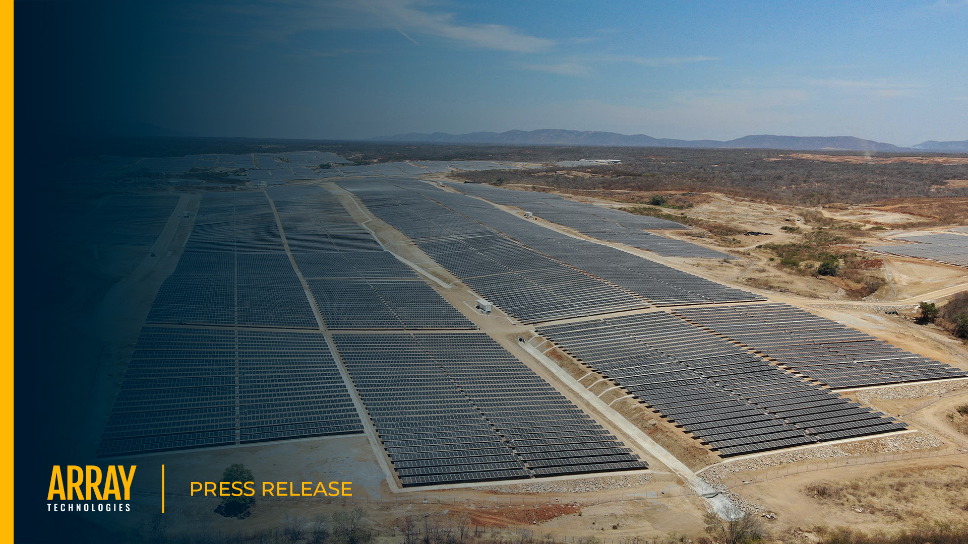 Press release cover image of an aerial view of a solar site with mountain in the background