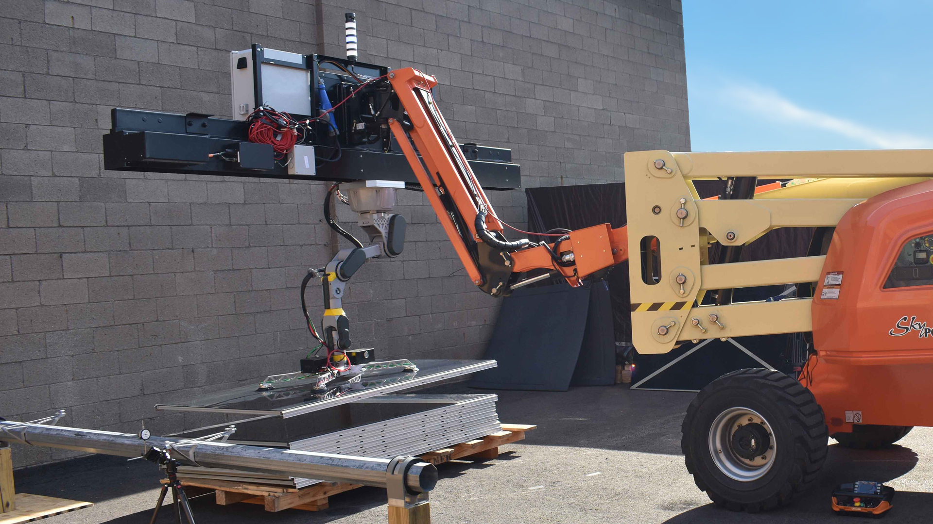 The SARCOS Sapien mobile robotic arm transferring a photovoltaic (PV) modules onto an ARRAY system.