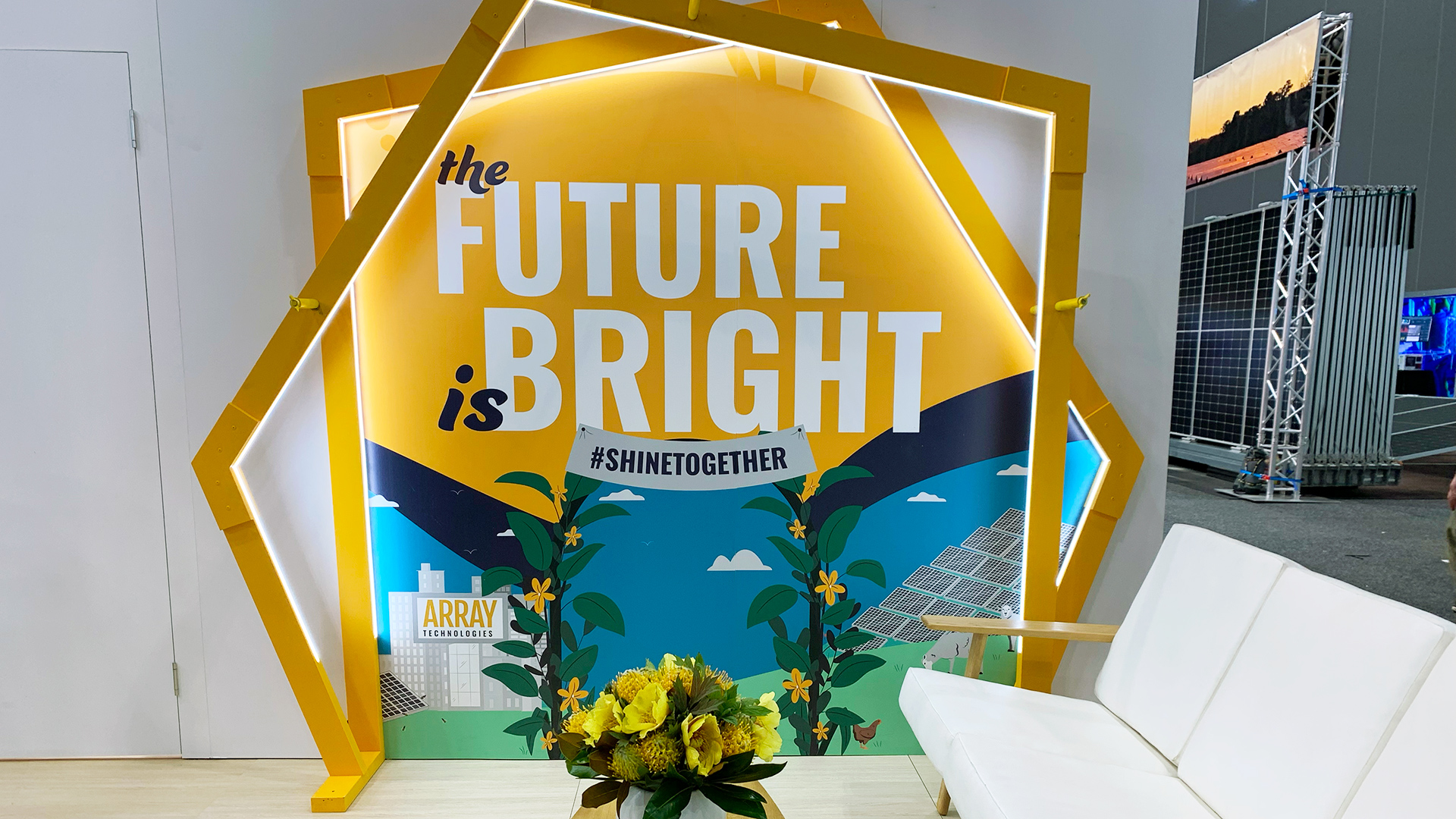 The Array Technologies trade show booth at All-Energy AU 2022 that reads "The future is bright. #ShineTogether"