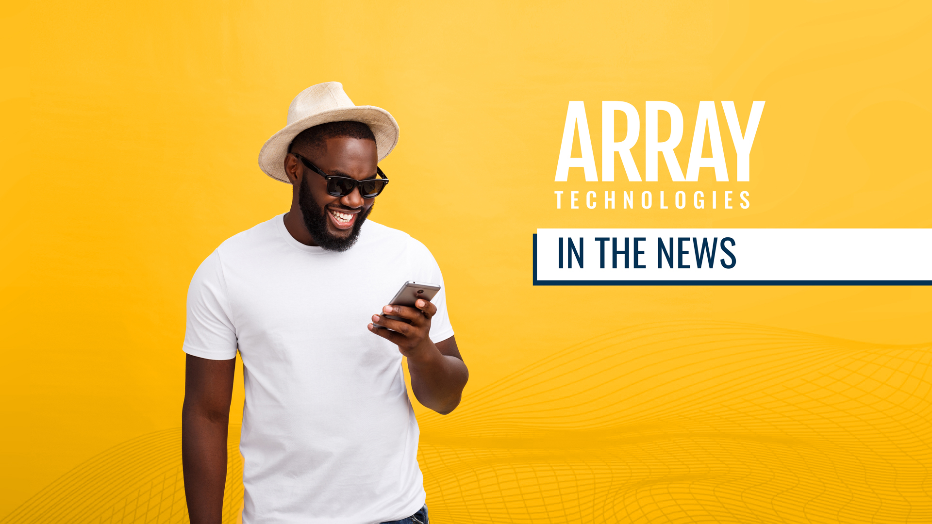 A cheerful Black man reading the news on his phone. Text on the image reads, "Array Technologies in the News"