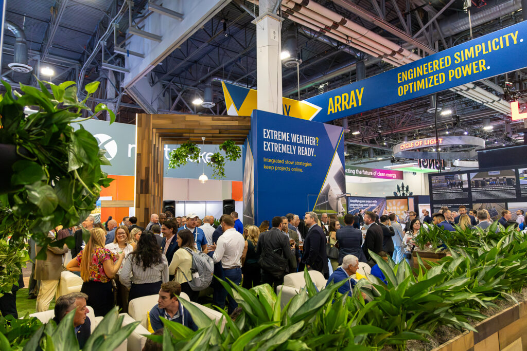 Crowd of people standing in the ARRAY tradeshow booth 
